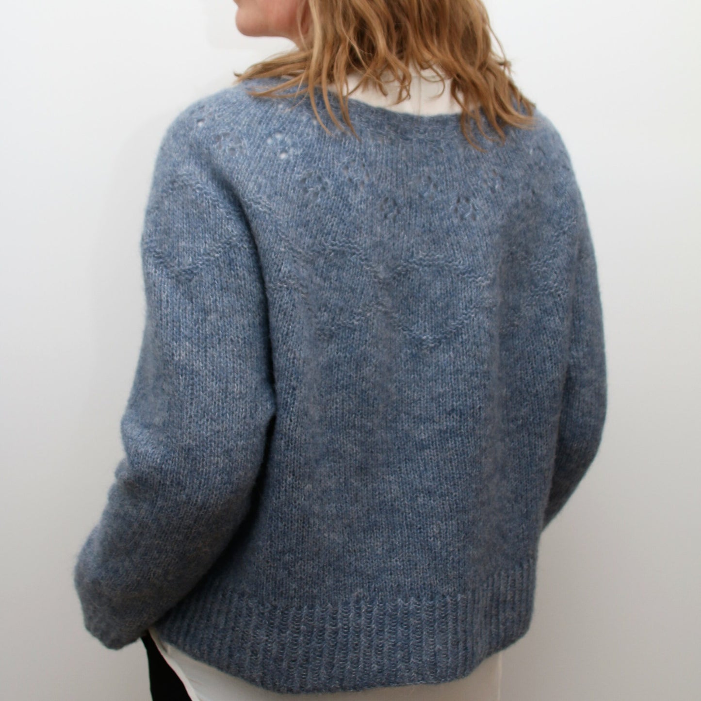 Woman wearing the Embla Sweater styled as an everyday Nordic wardrobe staple