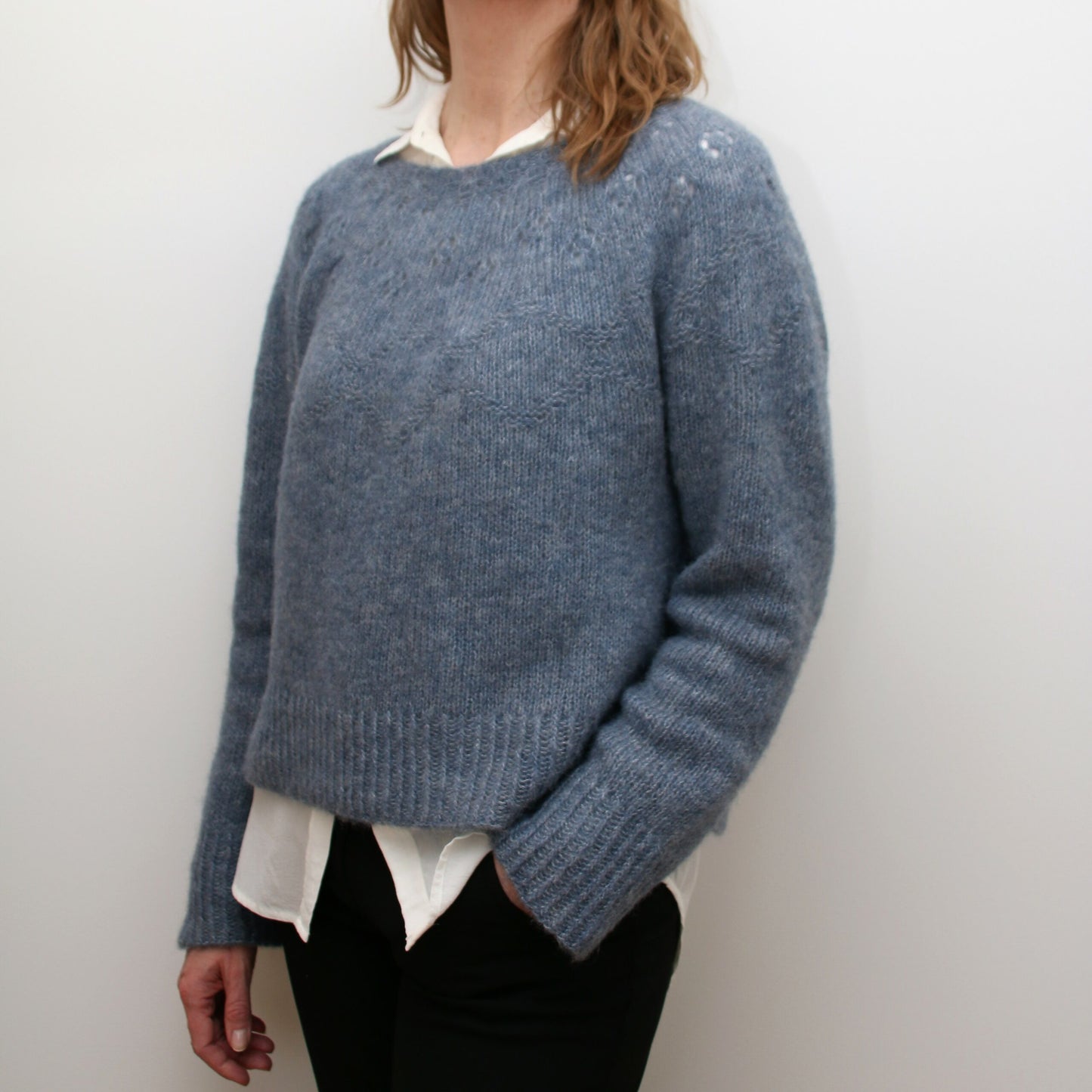 Side view of the Embla Sweater showing relaxed fit and elegant neckline
