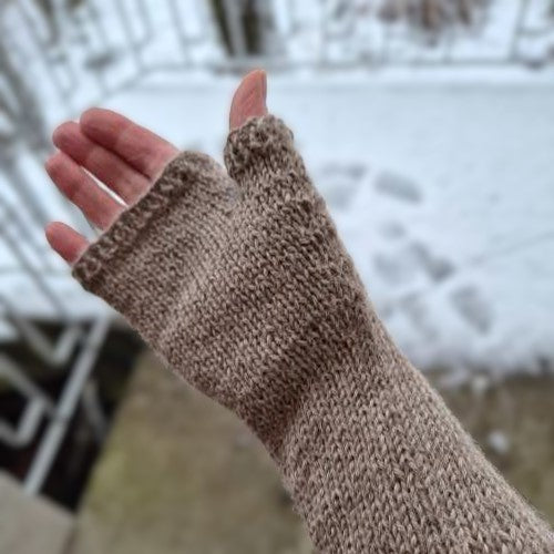Close up of refined Nordic style knitted hand warmers.